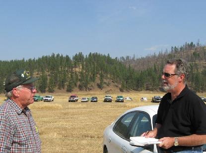 Forest Hayes explains to Clarke how they fight fires in the West. 